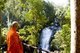 Thailand: Monk surveying the Sirithan Waterfall, Doi Inthanon (Thailand's highest mountain)